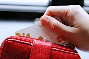 Hand zieht Karte aus Brieftasche